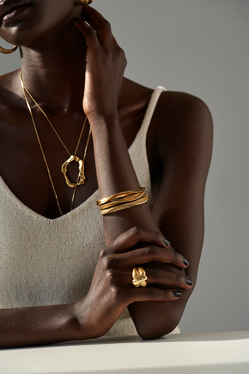 Tricia wearing Sterling King Lithop Ridge Bracelets in Gold paired with Molten Pendant and Lithop Hoops